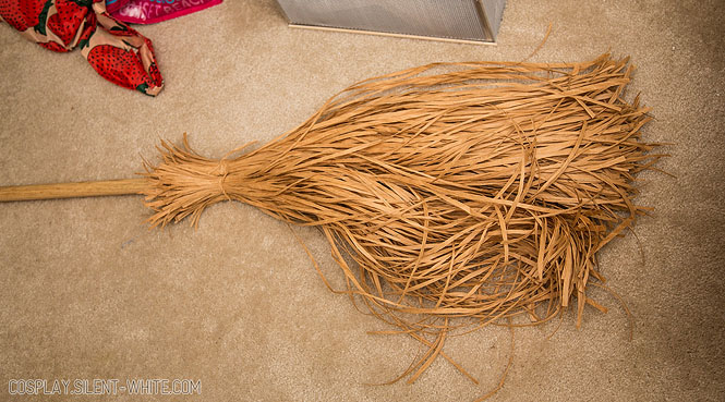4 bundles of raffia paper ribbon glued around the bottom of a broom stick