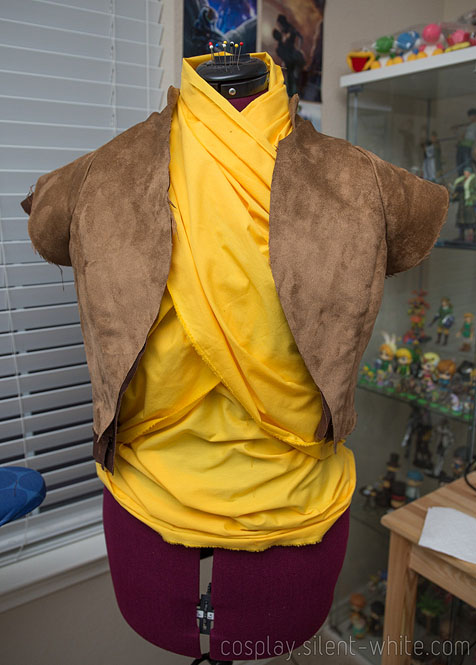 Raya's yellow shirt and brown vest on a dressform, partially done