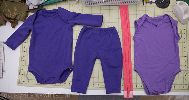 Noi costume shown in four pieces - long sleeve onesie, pants, onesie with no sleeves, and belt